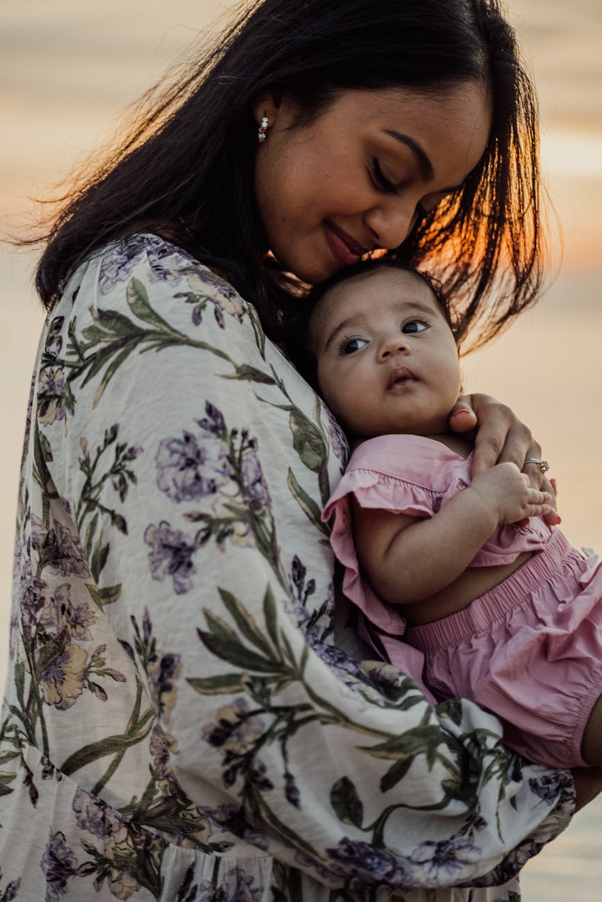 smiling woman looking at her baby