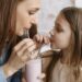 woman and child sharing a glass of milk shake